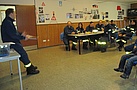 Die Helfer besprechen im Aufenthaltsraum der THW-Unterkunft die geplante Streckenführung und Besonderheiten des Fahrens als geschlossener Verband